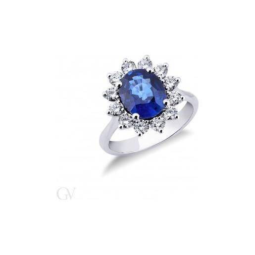 Gioielli di Valenza anello in oro bianco 18k con 12 diamanti a contorno e zaffiro blu centrale. 