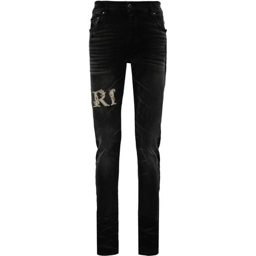 AMIRI jeans skinny con applicazione - nero